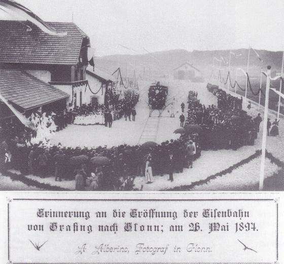 Eine Aufnahme der Eröffnung der Bahnstrecke GrafingGlonn am 26. Mai 1894, links das Empfangsgebäude des Bahnhofs Glonn, in der Mitte der Eröffnungszug, im Hintergrund der bis heute erhaltene Lokschuppen.	Foto: gemeinfrei
