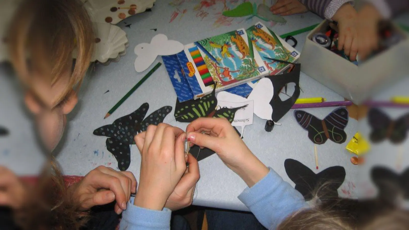 Gestalten und Verzieren der Schmetterlinge macht großen Spaß. Als Vorbilder dienen den kleinen Bastlern echte exotische Schmetterlinge, die im Botanischen Garten frei im Wasserpflanzenhaus fliegen. Natürlich können die Kids auch der Fantasie freien Lauf lassen und ihre Schmetterlinge individuell bemalen und schmücken. (Foto: Monika Jerg)