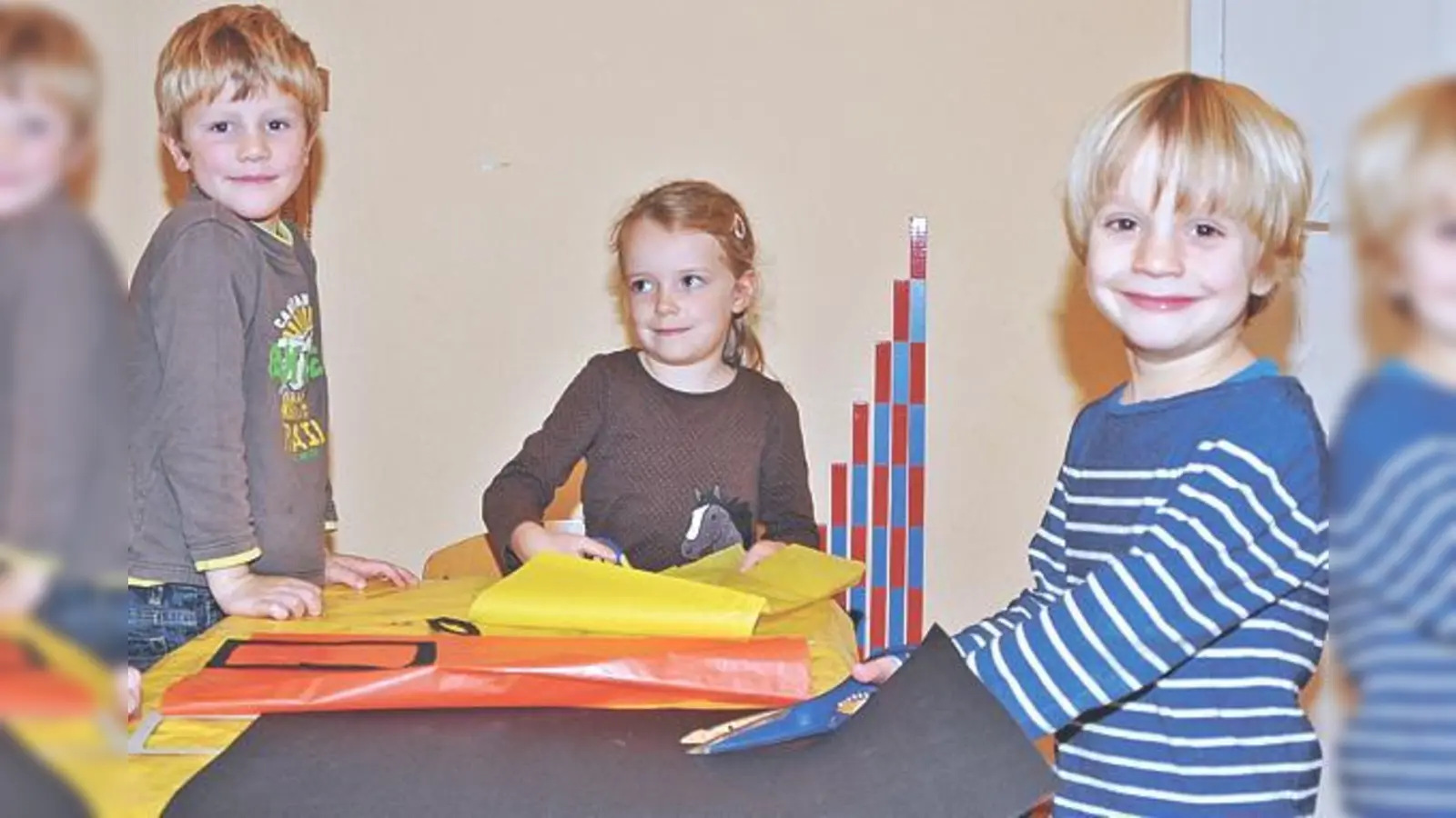 Vincent, Nelly und Ole, Vorschulkinder in der Baldhamer Elterninitiative Bährenhöhle, basteln schon fleißig Kerzen-Fensterbilder für den Rathaus-Adventskalender. 	 (Foto: sf)