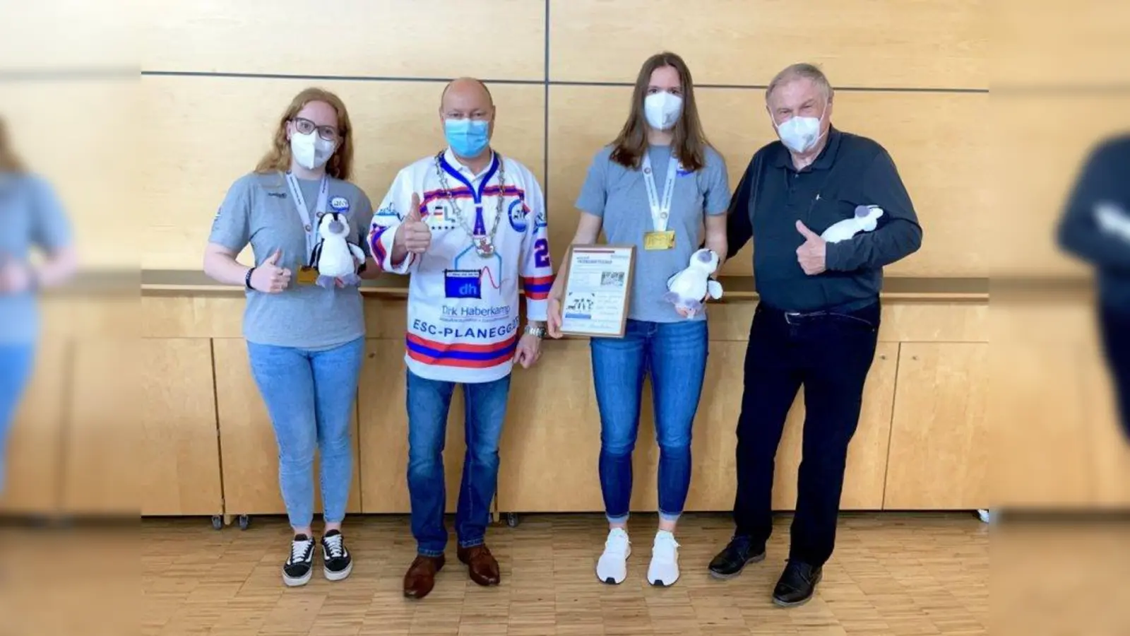 Bürgermeister Herrmann Nafziger  (2.v.l.) übereichte der Abordnung des ESC Planegg, Daniela Kolbeck (l.), Yvonne Rothemund (2.v.r.) und Klaus Wüst (r.), das Geschenk der Gemeinde - eine Pinguinpatenschaft im Tierpark Hellabrunn. (Foto: Gemeinde Planegg)