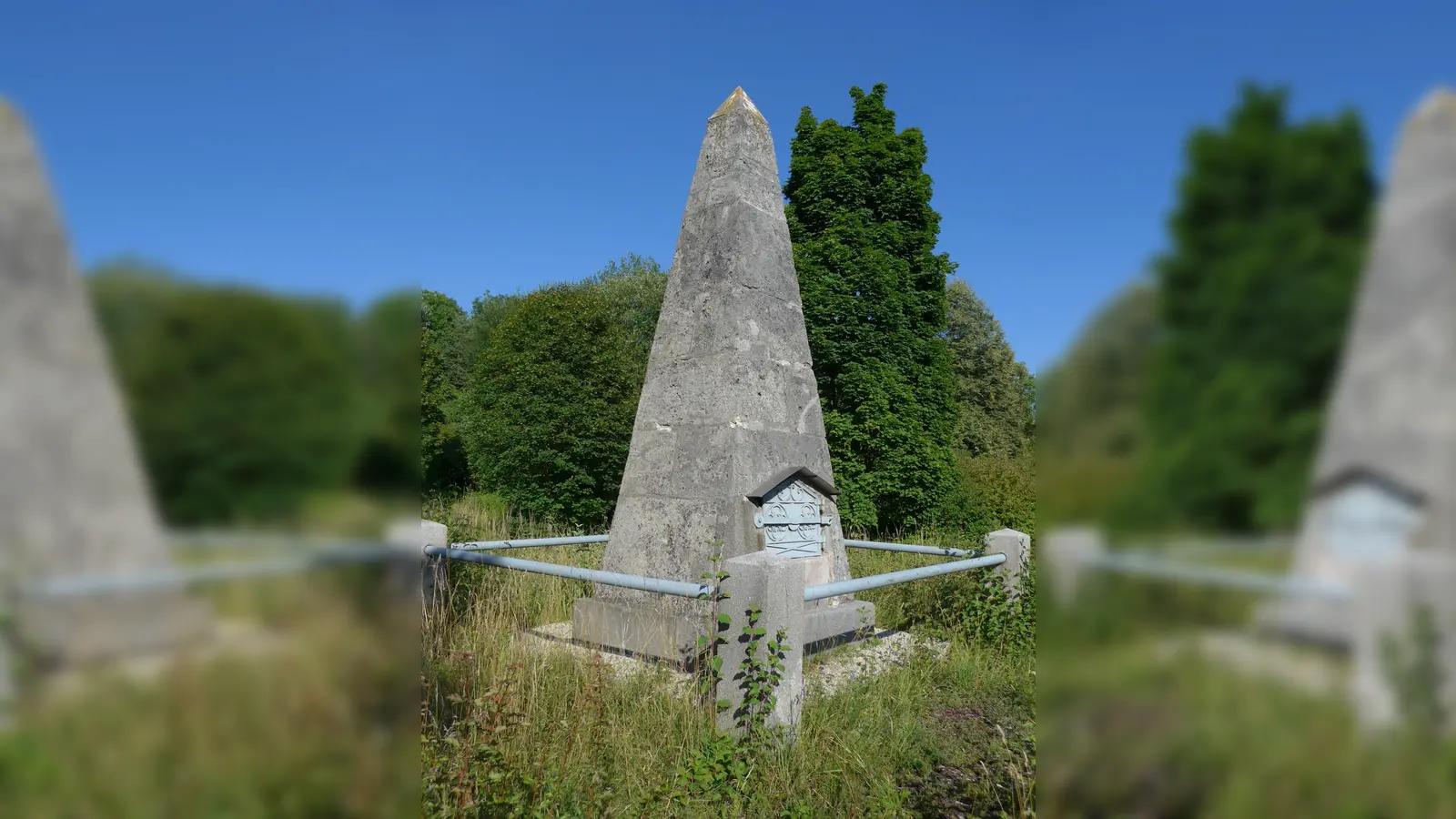 Die Basispyramide in Unterföhring erinnert an den Beginn der Landvermessung in Bayern. Ebenfalls unter Denkmalschutz stehen das Bürogebäude in der Brodersenstraße 36 und das Pumpen- und Floßwärterhäuschen in St. Emmeram. (Foto: Max Berger/CC BY-SA 4.0, gemeinfrei, Marsupilami/CC BY-SA 3.0)