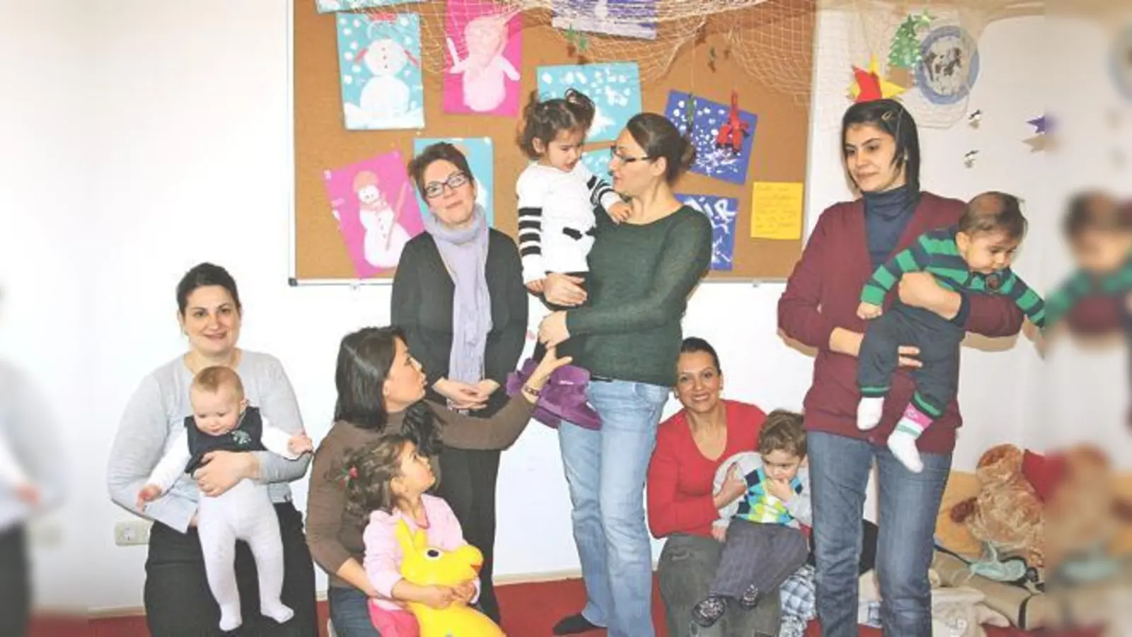 Erzieherin Eva Wäls (3. v. l.) ist hier mit ihrer Spielgruppe und den Müttern in den Räumen von Acilim. 	 (Foto: Julia Stark)