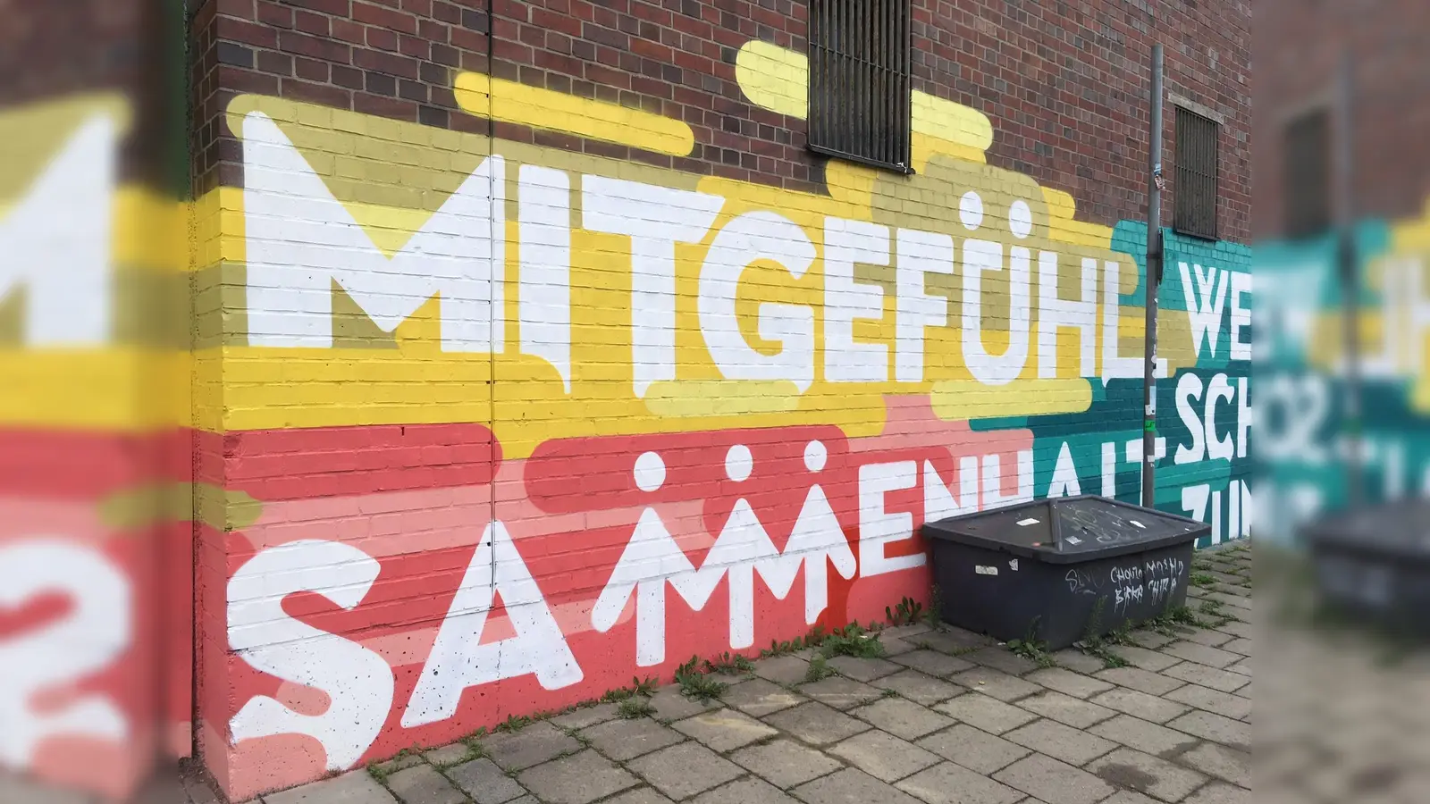 Mitgefühl füreinader zeigen - das wünschen sich die 30 Jugendlichen, die die Wand an der Thalkirchner Straße gestaltet haben. (Foto: lsc)