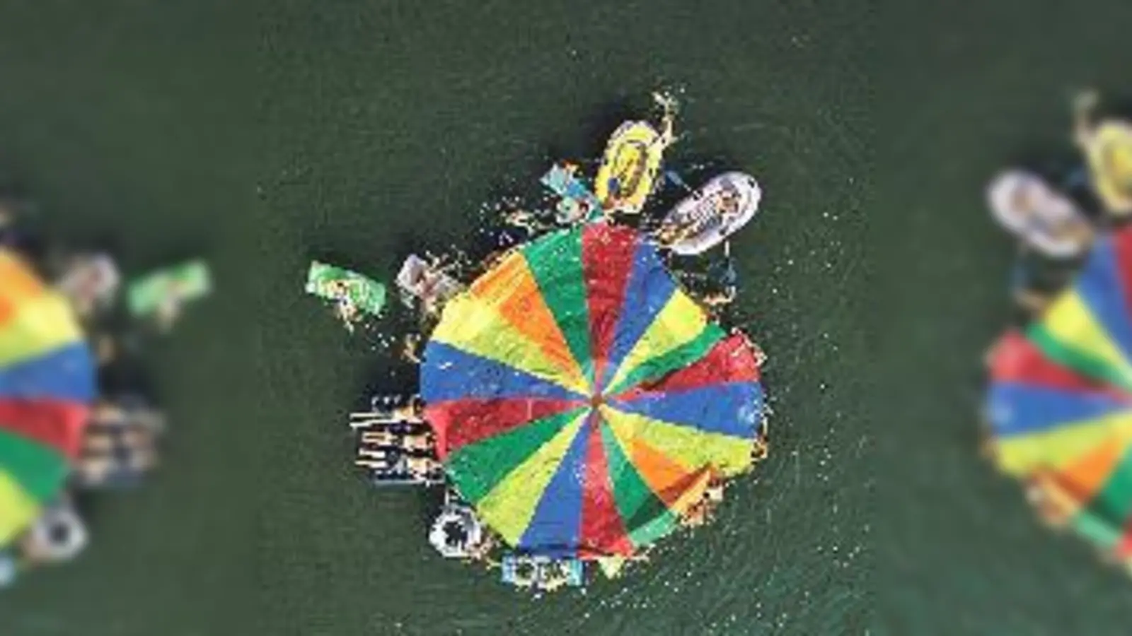 In der Mitte des Sees breiten sie einen großen, bunten Fallschirm aus.	 (Foto: VA)