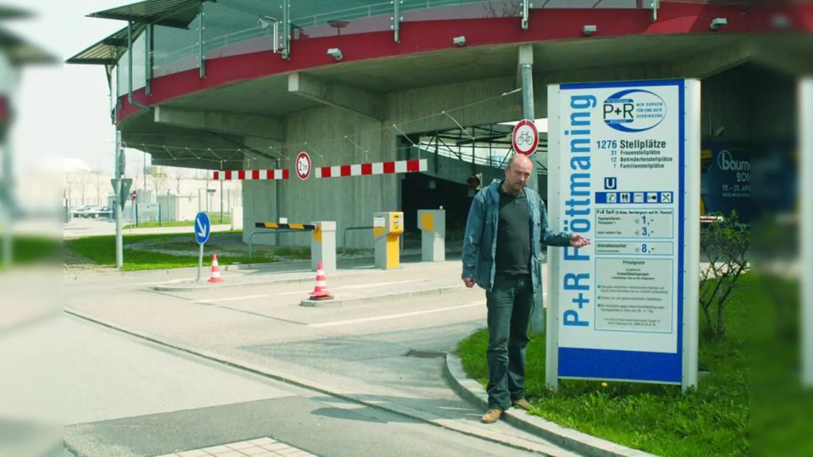 ADAC-Parkhausexperte Gerhard Willfahrt vor der Tafel mit Benutzungsordnung, Öffnungszeiten und Einstellgebühren in Fröttmaning. (Foto: sb)