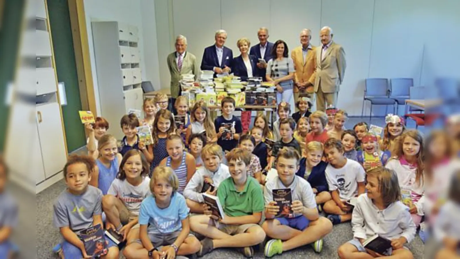 Die Mitglieder des Rotary Clubs Grünwald hatten jede Menge Bücher für die Kinder dabei: Yorck von Schmelling, Gero Seeliger, BR-Moderatorin Caroline Reiber, Joachim Reuther, Schulleitung Renate Zeiler Ihno Schneevoigt und Berhard Goppel. 	 (Foto: hw)