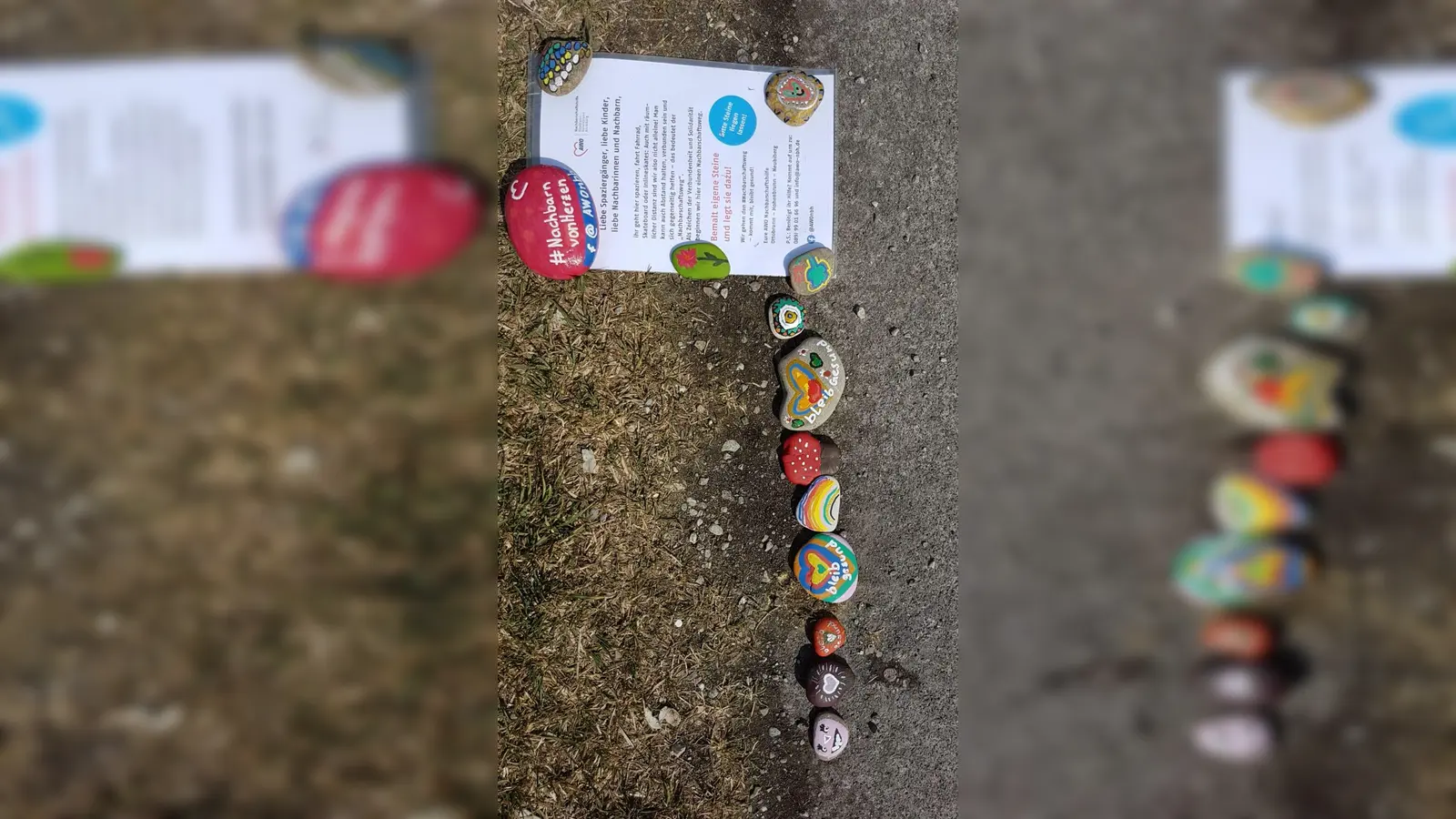 Eine Schlange aus bunten Steinen, die die Nachbarschaftshilfe initiiert hat, soll die Verbundenheit miteinander zeigen.  (Foto: VA)