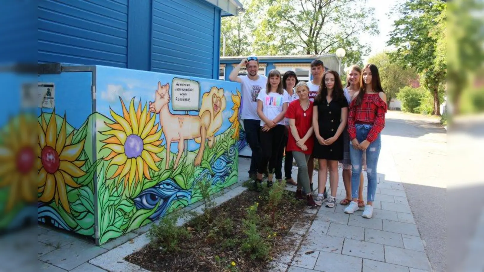 „Gemeinsam unterschiedlich gegen Rassismus“: Künstler Martin Blumöhr (links) zusammen mit Mechtild D’Sa (3. von links), Schulleiterin der Mittelschule an der Franz-Nißl-Straße, und Lehrerin Simone Menrath (2.von rechts) sowie den am Kunstprojekt beteiligten Schülern Karolina (2. von links), Nici (4. von links), Lara (3. von rechts), Nikolina (rechts) und Bensar (4. von rechts). (Foto: sb)