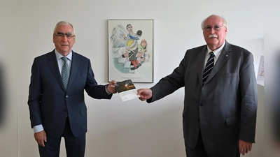 Volksbund-Landesvorsitzender Wilhelm Wenning übergibt die neue Publikation an Bundesminister a.D. Dr. Theo Waigel (links). (Foto: Volksbund)