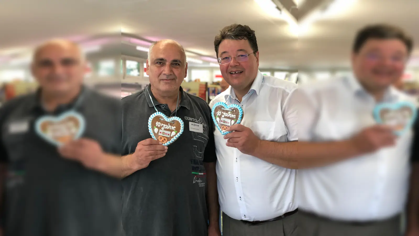 Bürgermeister Thomas Loderer (r.) gratuliert dem stellvertretenden Filialleiter vom Bonus-Markt in Ottobrunn, Athanasius Papadopoulos zum 10-jährigen Bestehen.  (Foto: Privat)