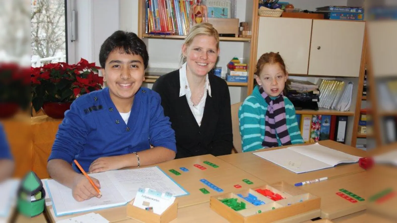 Sandra Krenn mit Fatih und Celine, die ihre Mathematikhausaufgaben machen. (Foto: bb)
