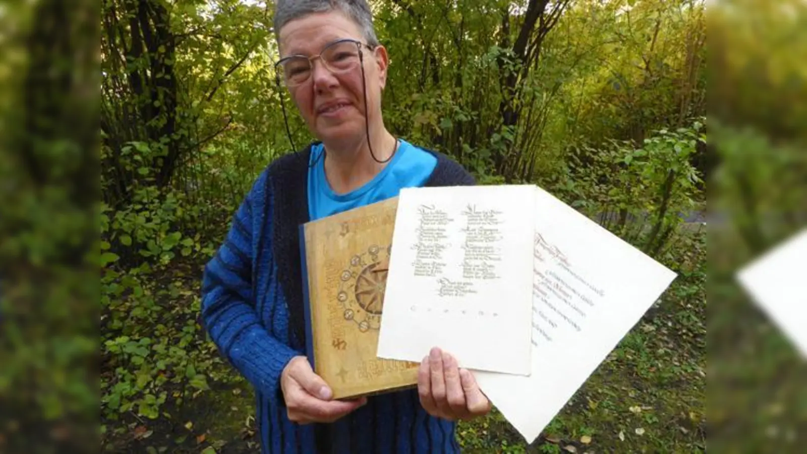 Die Giesingerin Monika Attensperger mit meisterlichen Kalligrafien, die ihr Vater, der Grafiker Toni Attensperger, Ende der 1940er Jahre angefertigt hat.  (Foto: VA)