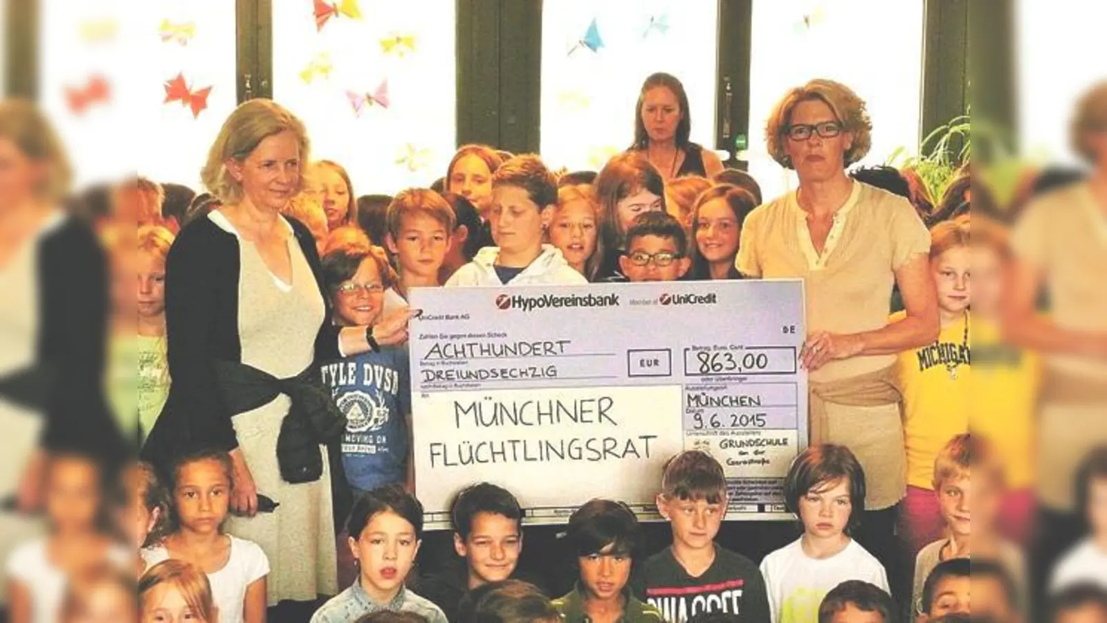 Elternbeiratsvorsitzende Beatrix Weber (rechts) und die Schüler überreichten Regine Novak vom Münchner Flüchtlingsrat den Scheck.	 (Foto: Elternbeirat)