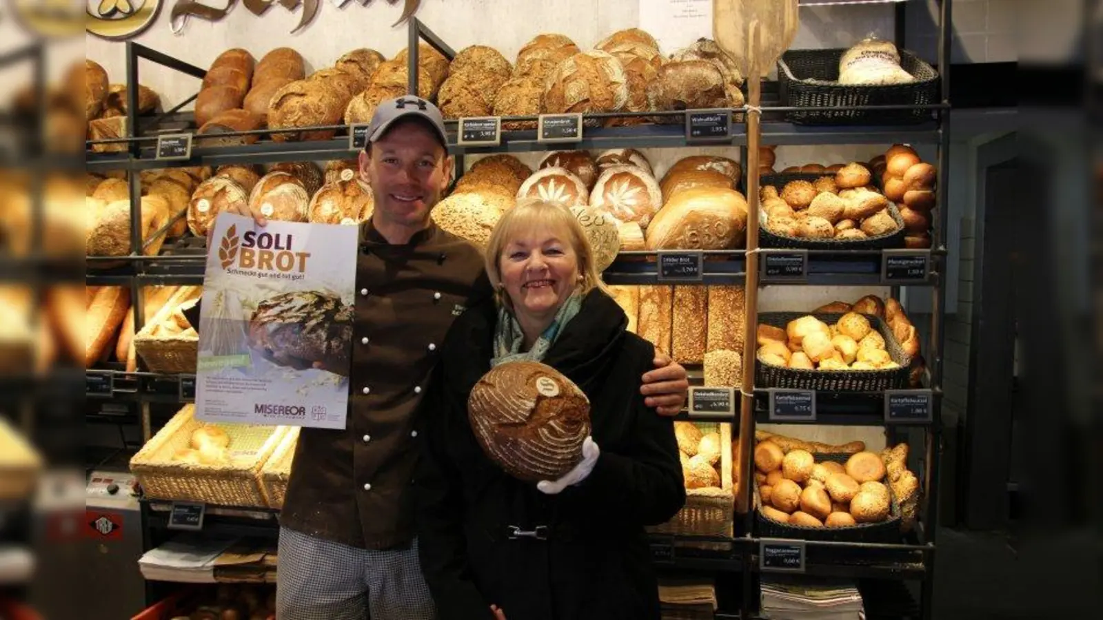 Solibrot: Matthias Schuhmair von der Bäckerei Schuhmaier unterstützt Monika Neidhardt, die mit dem Allacher Frauenbund die Aktion zum ersten Mal im 23. Stadtbezirk durchführt. (Foto: sb)