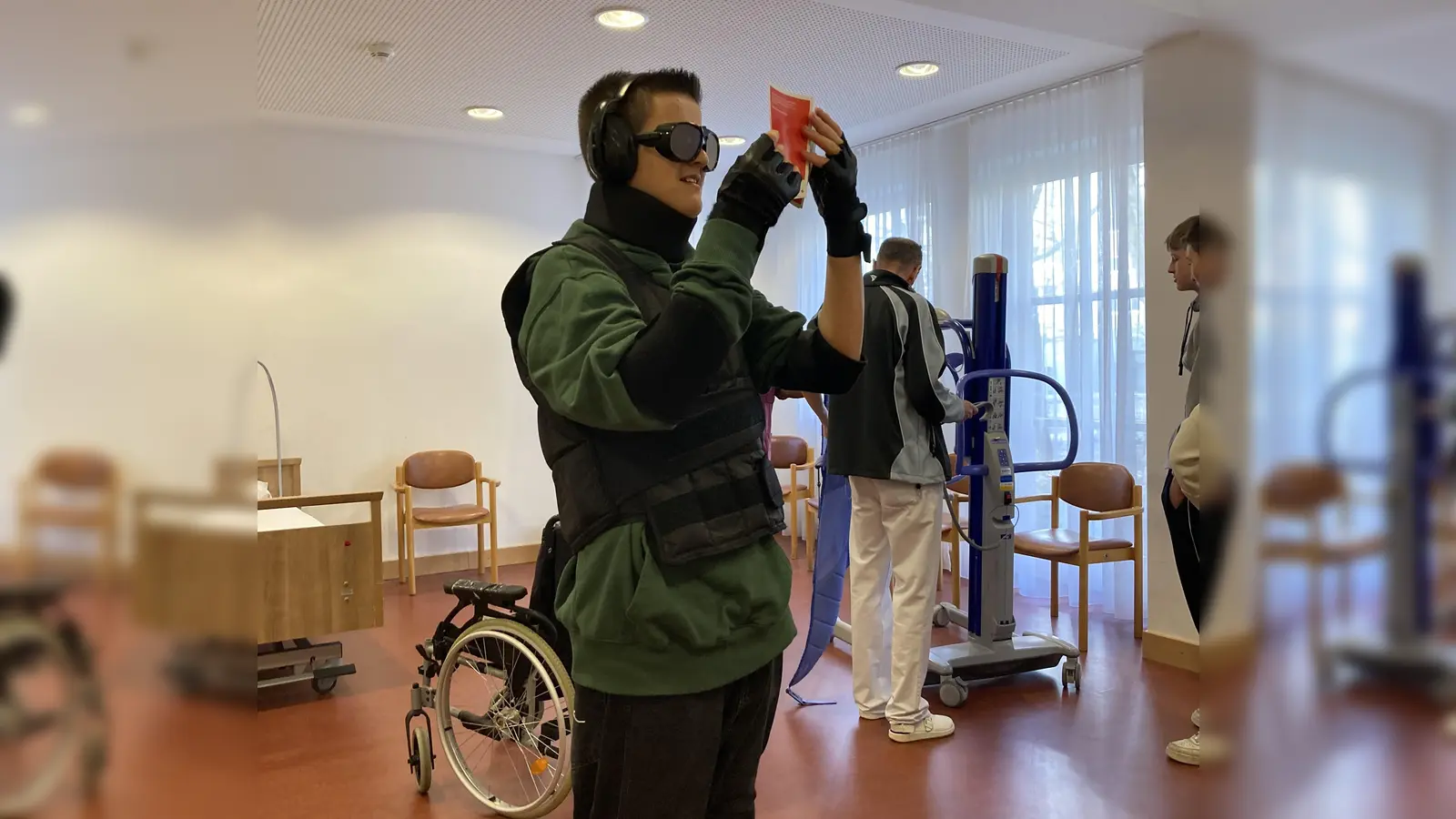 Ein Schüler der Realschule Freiham erfährt beim SeniorenWohnen des BRK in einem speziellen Anzug, wie es ist, im Alter sehbehindert, schwerhörig und in der Bewegung eingeschränkt zu sein. (Foto: Astrid Ziller )