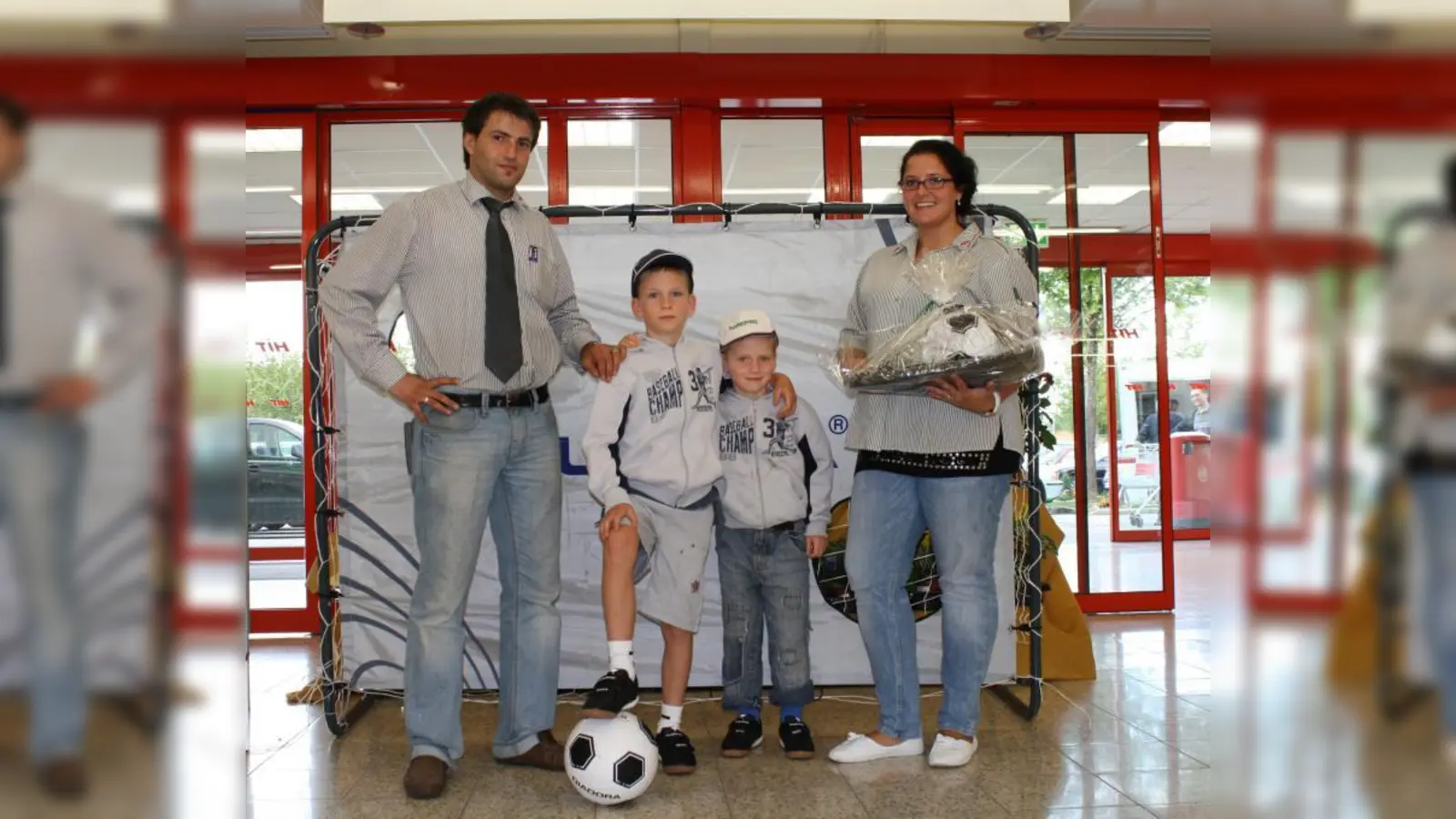Sebastian Schützinger (2.v.l.) zusammen mit seinem Bruder Leonhard, dem stellvertretenden Marktleiter Mustafa Yolcu und HIT-Mitarbeiterin Bianka Pozeg bei der Gewinnübergabe. (Foto: sb)