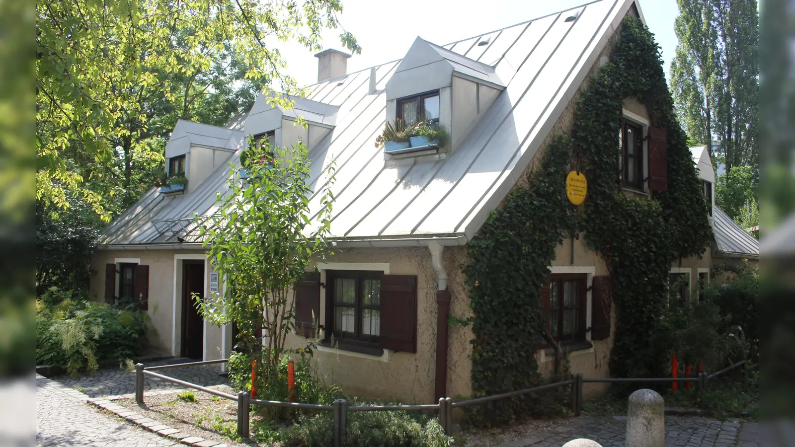 Im denkmalgeschützten Üblacker-Häusl bieten die "Freunde Haidhausens" Künstlern eine Ausstellungsfläche. Jetzt versteigert der Verein 50 ausgewählte Werke, darunter das Aquarell "Am Wiener Platz" von Jürgen Meyer-Andreaus (kleines Bild). (Foto: bs, Krista Glass)