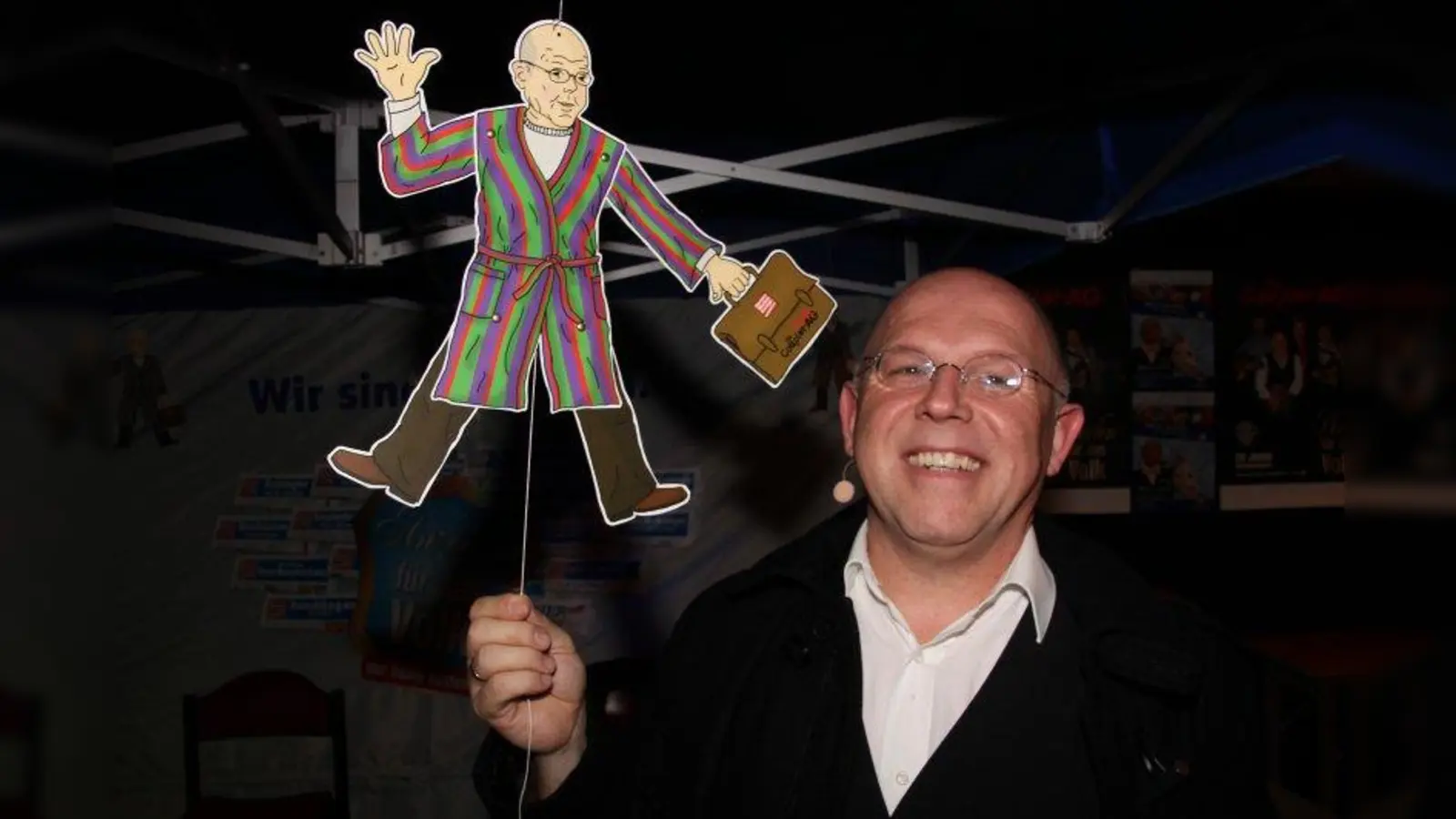 Jürgen Kirner mit seinem Alter Ego, dem Dr. Kudernak: Der eine lacht, der andere winkt. (Foto: © Robert Allmeier, Stadtmagazin München 24)