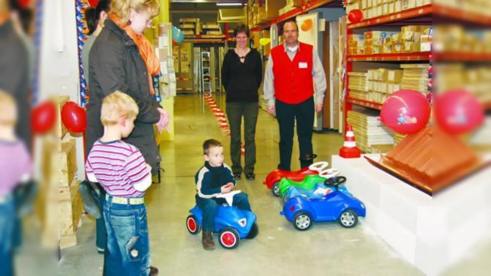 Die jüngsten Baumarktbesucher hatten Spaß bei ihrer Runde durch den Bobbycar-Parcours; Carina Albrecht (Mitte) von der Geschäftsleitung der Kinderkrippe Krabbeleck betreute gemeinsam mit einigen Müttern diese Aktion. (Foto: Eva Schraft)