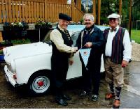 Schlüsselübergabe: Rudolf Batzer (links) und Peter Dennemark (rechts) übergeben die Zündschlüssel zum restaurierten Trabant an Rolf Zeitler. Foto: VA