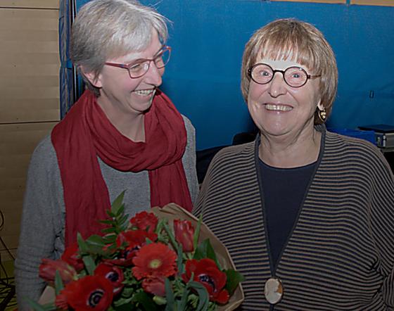 Ein Dankeschön mit Blumenstrauß und warme Worte gab es für die Bezirksausschussvorsitzende Adelheid Dietz-Will (rechts) auf ihrer letzten Bürgerversammlung. Links SPD-Fraktionskollegin Nina Reitz. Foto: SPD Au-Haidhausen