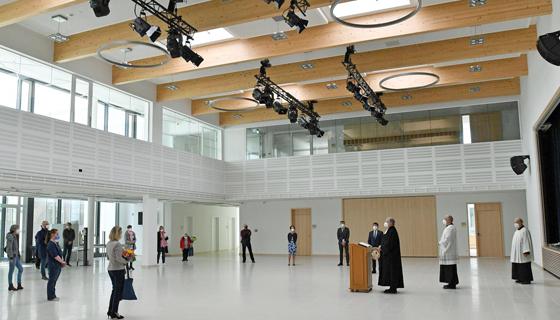 Die Aula der neuen Grundschule an der Mitterfeldallee, aufgenommen während der Segnungsrede von Pfarrer Carsten Klingenberg. Foto: Gemeinde Unterföhring/foe