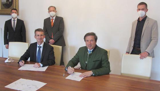 Klaus Günther (MTU) und OB Max Gotz (vorne, von links) unterzeichnen die Absichtserklärung. Mario Külgen, Michael Hergeth (beide MTU) und Christian Famira-Parcsetich (Stadtentwicklung) beobachten den Vorgang (hinten, von links). F: Stadt Erding
