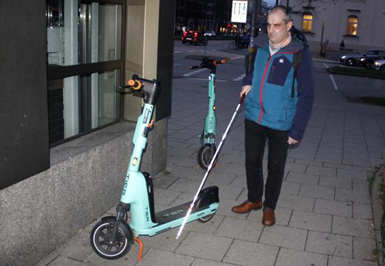 Am Laimer Platz erklärt Stefan Unterstraßer, warum auf dem Gehweg zurückgelassene Roller für blinde Mitbürger wie ihn gefährliche Stolperfallen sind. Foto: job