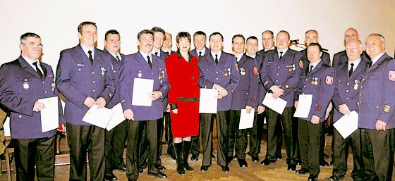 Bürgermeisterin Christine Strobel (in Rot) ehrte die Feuerwehrmänner.	Foto: Feuerwehr